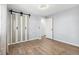 Bedroom featuring wood flooring, a frosted sliding closet door, and fresh paint at 4860 S Field Way, Littleton, CO 80123