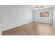 Bedroom featuring neutral paint, wood-look floors, and large window at 4860 S Field Way, Littleton, CO 80123