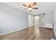 Spacious bedroom featuring wood-look floors and a sliding door to en-suite bathroom at 4860 S Field Way, Littleton, CO 80123