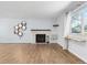 Bright living room with light wood floors, a fireplace, and a honeycomb shelf at 4860 S Field Way, Littleton, CO 80123