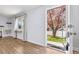 Bright living room with light wood floors, a built-in desk, and a view of the front yard at 4860 S Field Way, Littleton, CO 80123