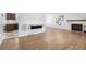 Spacious living room with light wood floors, fireplace, and views to the kitchen at 4860 S Field Way, Littleton, CO 80123