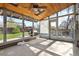 Bright sunroom with wood ceiling, skylights, shelves, and large windows offering backyard views at 4860 S Field Way, Littleton, CO 80123