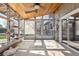 Bright sunroom with wood ceiling, skylights, shelves, and large windows offering backyard views at 4860 S Field Way, Littleton, CO 80123