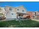 Green backyard featuring a covered patio with a hot tub and outdoor seating at 6021 Lynx Creek Cir, Erie, CO 80516