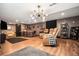 Finished basement featuring a wet bar, theater seating, and wood-look floors at 6021 Lynx Creek Cir, Erie, CO 80516
