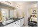Bathroom features a dual vanity and neutral finishes, connecting to a well-lit bedroom at 6021 Lynx Creek Cir, Erie, CO 80516