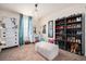 Bright bedroom featuring a vanity, shoe rack, modern decor and a beautiful chandelier at 6021 Lynx Creek Cir, Erie, CO 80516