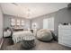 Cozy bedroom with chandelier, stylish decor, and a soft gray color scheme at 6021 Lynx Creek Cir, Erie, CO 80516
