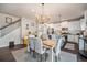 Dining and kitchen area featuring an island, stainless steel appliances, and open staircase at 6021 Lynx Creek Cir, Erie, CO 80516