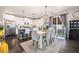 Bright dining area adjacent to the kitchen with stainless steel appliances and island seating at 6021 Lynx Creek Cir, Erie, CO 80516