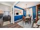 Elegant dining room showcasing blue accent wall, chandelier, and an adjoining living space at 6021 Lynx Creek Cir, Erie, CO 80516
