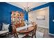 Formal dining room featuring wood furniture, chandelier and decorative china cabinet with plates at 6021 Lynx Creek Cir, Erie, CO 80516