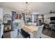 Open-concept dining area with access to the backyard, flowing into the living room with a fireplace at 6021 Lynx Creek Cir, Erie, CO 80516