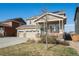Charming two-story home with a three-car garage, covered porch, and solar panels for energy efficiency at 6021 Lynx Creek Cir, Erie, CO 80516
