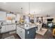 Open kitchen and dining space with island and living room in the background, great for entertaining at 6021 Lynx Creek Cir, Erie, CO 80516