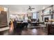 Open-concept living room with hardwood floors, fireplace, and staircase leading to upper level at 6021 Lynx Creek Cir, Erie, CO 80516
