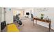 Open-concept living area with an exercise bike and neutral color palette for a welcoming atmosphere at 6021 Lynx Creek Cir, Erie, CO 80516
