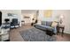 Comfortable living room with a gray sofa, accent pillows and a cozy rug at 6021 Lynx Creek Cir, Erie, CO 80516