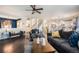 Bright living room showcasing hardwood floors, comfortable seating, and a glimpse of the open kitchen at 6021 Lynx Creek Cir, Erie, CO 80516