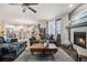 Open concept featuring a living room with hardwood floors, fireplace, and a view of the kitchen at 6021 Lynx Creek Cir, Erie, CO 80516