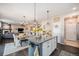 Open kitchen view to the dining and living area with a fireplace, perfect for modern living at 6021 Lynx Creek Cir, Erie, CO 80516