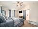 Comfortable main bedroom featuring a ceiling fan, tv and bathroom with barn door access at 6021 Lynx Creek Cir, Erie, CO 80516