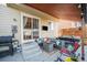 Inviting covered patio with outdoor seating, hot tub, and a built-in grill area at 6021 Lynx Creek Cir, Erie, CO 80516