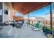 Relaxing outdoor patio with comfortable seating, a hot tub, and colorful landscaping at 6021 Lynx Creek Cir, Erie, CO 80516