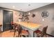 Basement bar featuring wood countertop, shelving, and seating, perfect for entertaining at 6021 Lynx Creek Cir, Erie, CO 80516