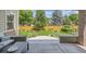 View of lovely fenced backyard from a covered patio seating area with an outdoor table and chairs at 3890 Tabor Ct, Wheat Ridge, CO 80033