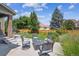 Outdoor patio seating area set up for dining and entertaining in a landscaped backyard at 3890 Tabor Ct, Wheat Ridge, CO 80033