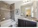 Stylish bathroom featuring a tiled shower and a dark vanity with granite countertops at 3890 Tabor Ct, Wheat Ridge, CO 80033