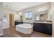 En-suite bathroom features a soaking tub and double vanity with modern fixtures at 3890 Tabor Ct, Wheat Ridge, CO 80033