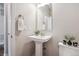 Powder room features a pedestal sink with neutral paint and modern fixtures at 3890 Tabor Ct, Wheat Ridge, CO 80033