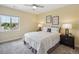 Cozy bedroom featuring a ceiling fan, a bright window and neutral decor at 3890 Tabor Ct, Wheat Ridge, CO 80033
