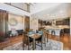 Spacious dining room featuring a view of the kitchen, a large sliding barn door to the office and wood floors at 3890 Tabor Ct, Wheat Ridge, CO 80033