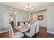 Open concept dining room with a modern chandelier and wood floors at 3890 Tabor Ct, Wheat Ridge, CO 80033