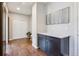 Hallway featuring hardwood floors, storage cabinets, and access to closet at 3890 Tabor Ct, Wheat Ridge, CO 80033