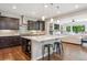 Open concept kitchen with a spacious island, pendant lighting, and hardwood floors at 3890 Tabor Ct, Wheat Ridge, CO 80033