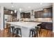 Stylish kitchen features a large island, dark wood cabinets, and stainless steel appliances at 3890 Tabor Ct, Wheat Ridge, CO 80033