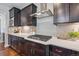 Modern kitchen with a gas cooktop, quartz countertops, and subway tile backsplash at 3890 Tabor Ct, Wheat Ridge, CO 80033