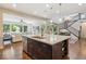 Bright kitchen features a center island, stainless steel appliances, and opens to dining area at 3890 Tabor Ct, Wheat Ridge, CO 80033