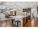 Kitchen island with stainless steel appliances, seating, and decorative pendant lighting at 3890 Tabor Ct, Wheat Ridge, CO 80033