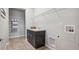 Functional laundry room with a utility sink, and storage shelves at 3890 Tabor Ct, Wheat Ridge, CO 80033