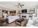 Open-concept living room and kitchen area, with modern fireplace, fan, and wood floors at 3890 Tabor Ct, Wheat Ridge, CO 80033