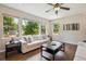 Bright and airy living room with large windows, ceiling fan and hardwood floors at 3890 Tabor Ct, Wheat Ridge, CO 80033