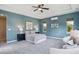 Spacious Primary bedroom with blue walls, carpeting, and natural light at 3890 Tabor Ct, Wheat Ridge, CO 80033