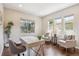 Bright home office with large windows, hardwood floors, and comfortable seating at 3890 Tabor Ct, Wheat Ridge, CO 80033