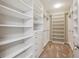 Spacious walk-in closet with custom shelving and drawers for optimal organization and storage at 3890 Tabor Ct, Wheat Ridge, CO 80033